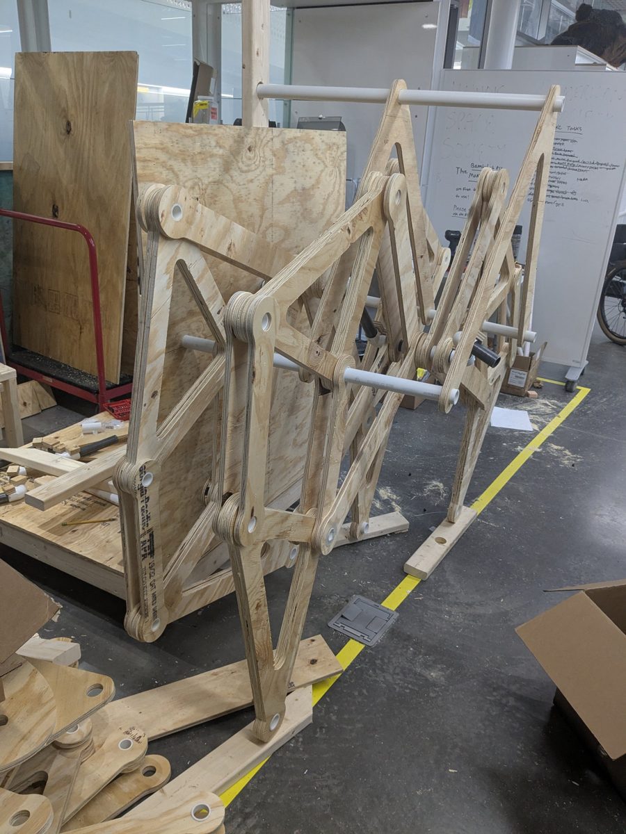 One side of the walker partially assembled, with legs mounted on PVC shafts